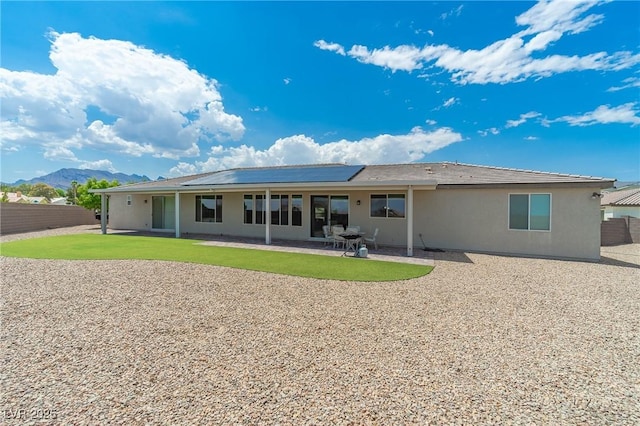 back of property with a patio area and a mountain view