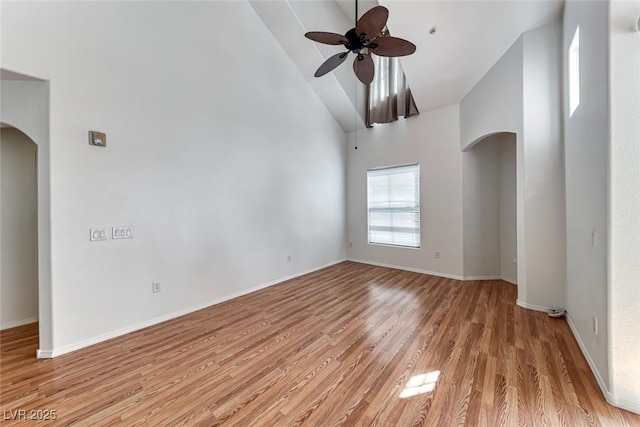 empty room featuring ceiling fan, light hardwood / wood-style floors, and high vaulted ceiling