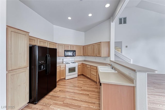 kitchen with kitchen peninsula, sink, black appliances, high vaulted ceiling, and light brown cabinets