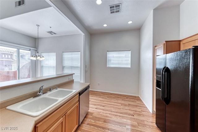 kitchen featuring hanging light fixtures, sink, black refrigerator with ice dispenser, an inviting chandelier, and stainless steel dishwasher