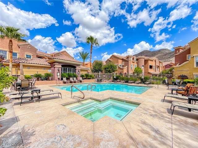 view of swimming pool with a community hot tub and a patio area