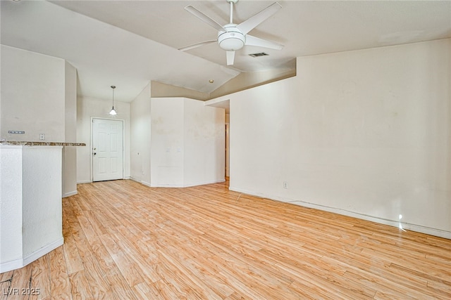 empty room with light wood-type flooring, ceiling fan, and lofted ceiling