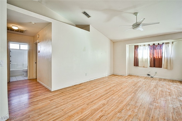 unfurnished room featuring ceiling fan, vaulted ceiling, and light hardwood / wood-style flooring