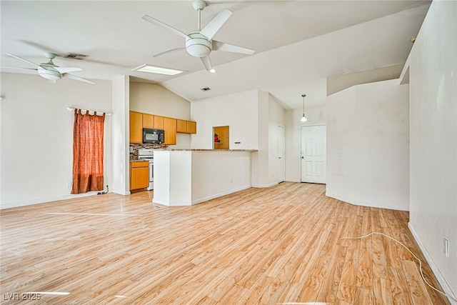 unfurnished living room featuring ceiling fan, vaulted ceiling, basketball hoop, and light hardwood / wood-style flooring