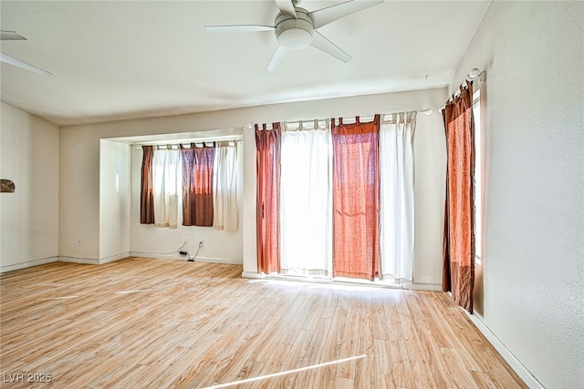 unfurnished room with ceiling fan and light hardwood / wood-style floors