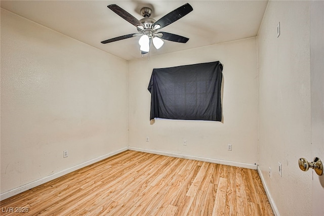 spare room with ceiling fan and light wood-type flooring