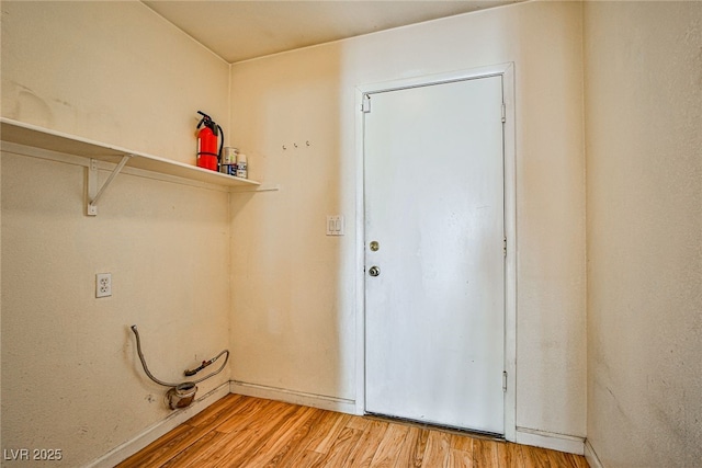 laundry area featuring hardwood / wood-style floors