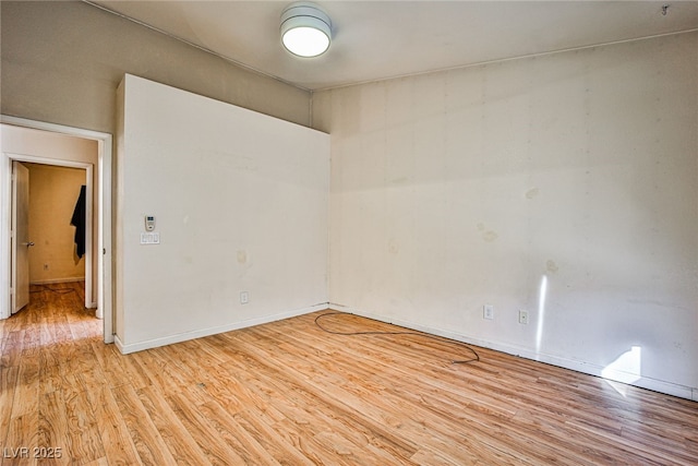 empty room with light hardwood / wood-style flooring