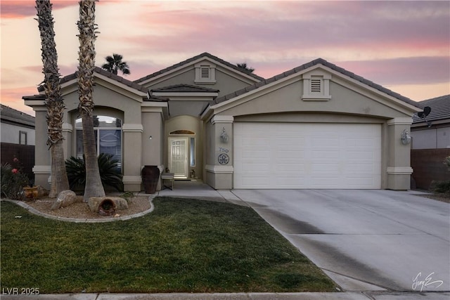 view of front of property featuring a yard and a garage