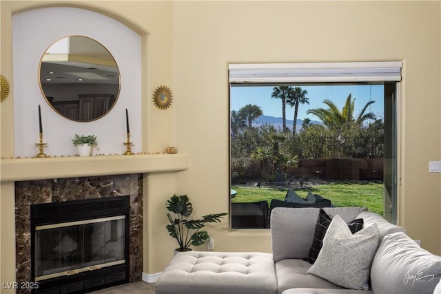 living room featuring a premium fireplace and plenty of natural light