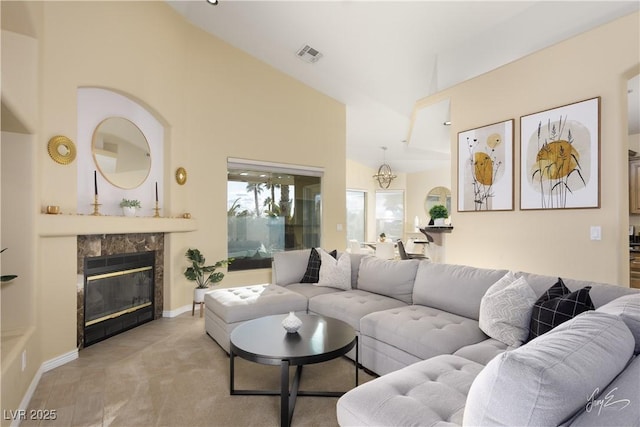 living room with light carpet, vaulted ceiling, and a high end fireplace