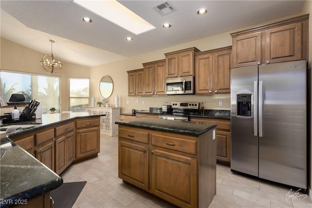 kitchen with a center island, decorative light fixtures, stainless steel appliances, lofted ceiling, and an inviting chandelier