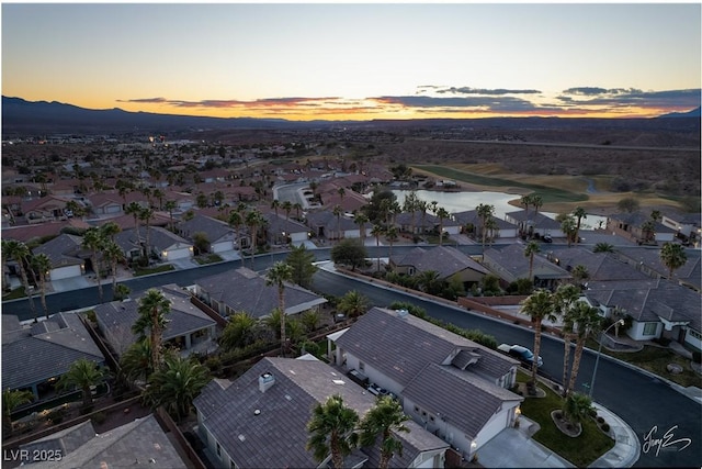 aerial view at dusk with a water view