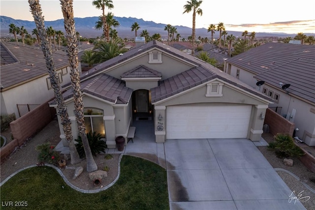 view of front of home featuring a garage and a mountain view