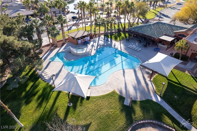 view of swimming pool with a yard and a patio