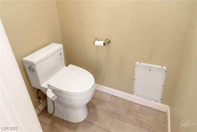 bathroom with tile patterned flooring and toilet