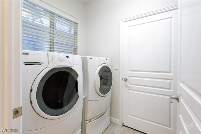 clothes washing area with washing machine and clothes dryer