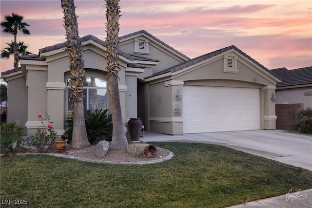 view of front facade with a lawn and a garage