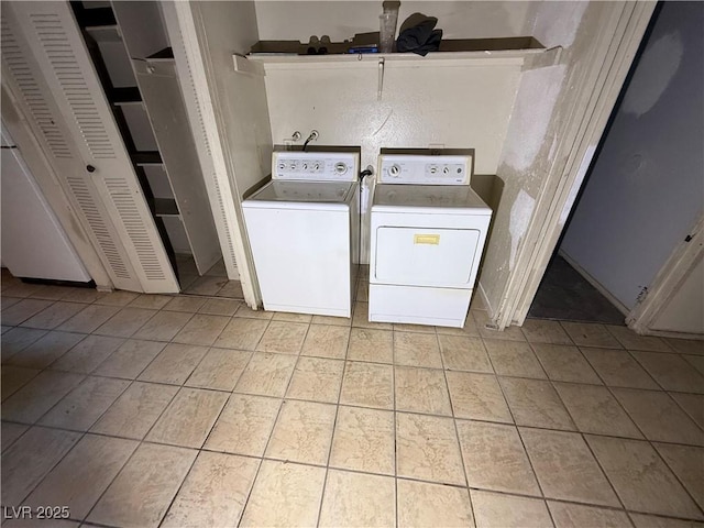 laundry area with light tile patterned flooring and washer and clothes dryer