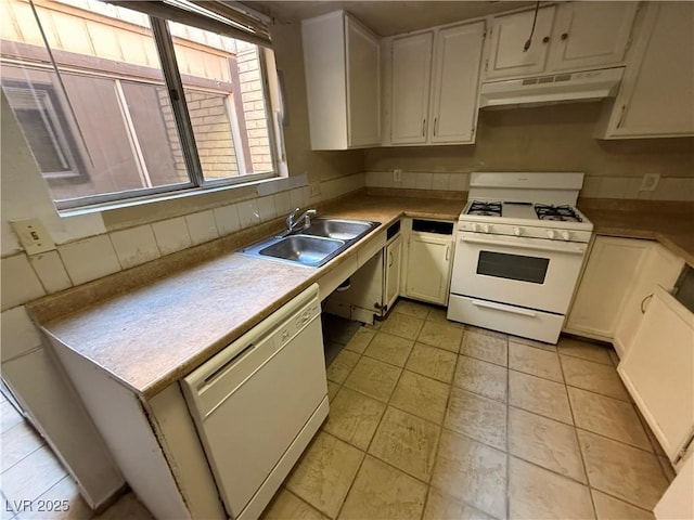 kitchen with white appliances, white cabinets, light tile patterned flooring, and sink