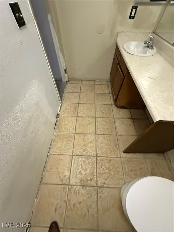 bathroom with tile patterned floors, vanity, and toilet