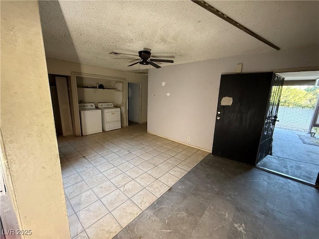 interior space featuring a textured ceiling, ceiling fan, and independent washer and dryer