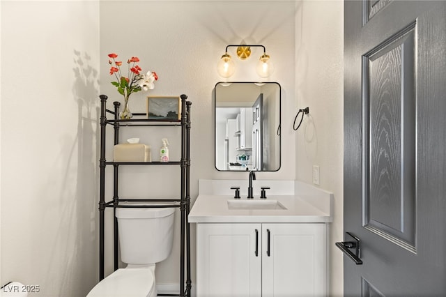 bathroom with toilet and vanity