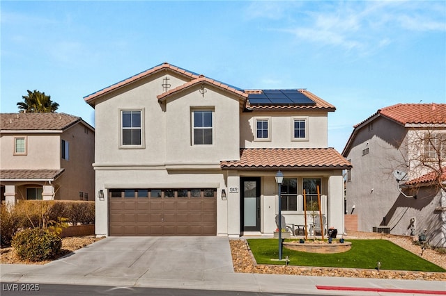 mediterranean / spanish house with solar panels, a porch, a front lawn, and a garage