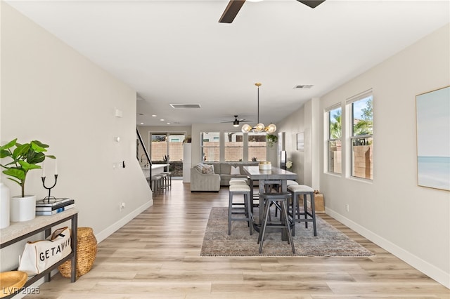 dining area featuring ceiling fan and light wood-type flooring