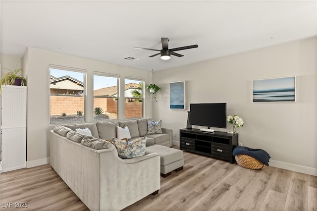 living room with ceiling fan and light hardwood / wood-style flooring