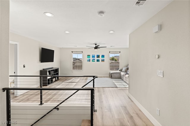 living room featuring wood-type flooring and ceiling fan