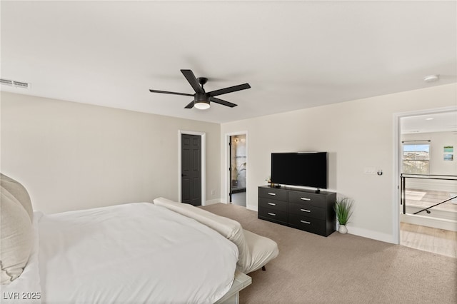 bedroom with a closet, ceiling fan, carpet, and connected bathroom