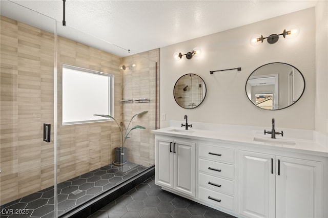 bathroom with vanity, an enclosed shower, and tile patterned floors