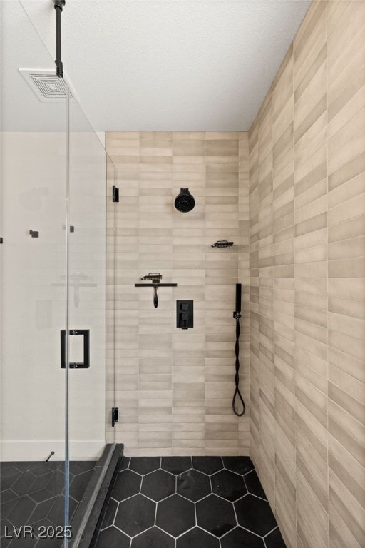 bathroom featuring a shower with shower door and tile patterned floors