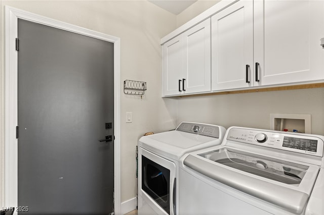 laundry area with separate washer and dryer and cabinets