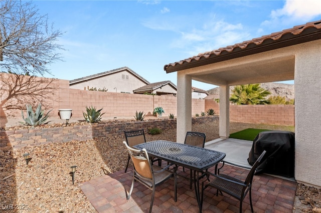 view of patio featuring a grill