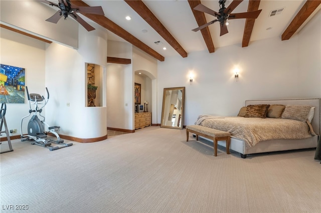 bedroom with ceiling fan, light colored carpet, and beam ceiling