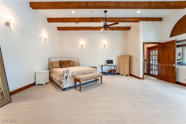 carpeted bedroom with ceiling fan and beamed ceiling