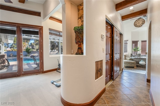 hallway with carpet and beamed ceiling