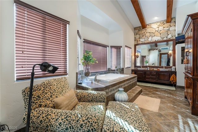 bathroom with beam ceiling, vanity, and a bathing tub