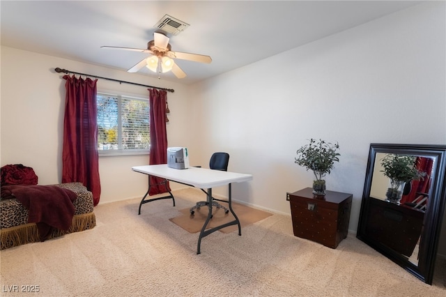 carpeted home office featuring ceiling fan