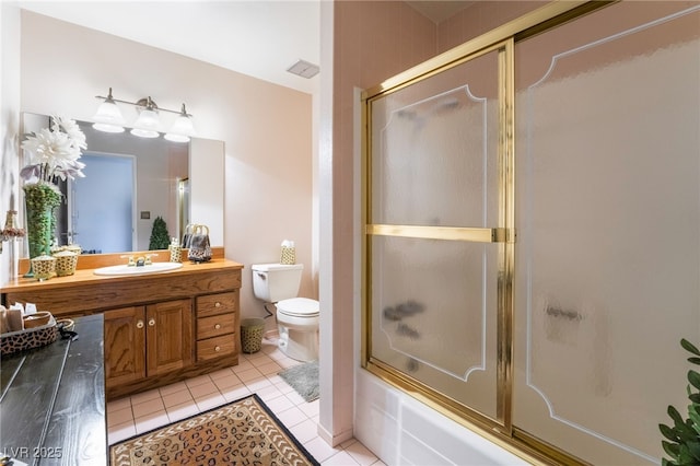 full bathroom featuring vanity, shower / bath combination with glass door, tile patterned floors, and toilet