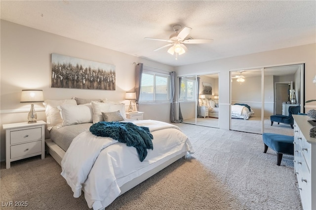 carpeted bedroom with ceiling fan and a textured ceiling