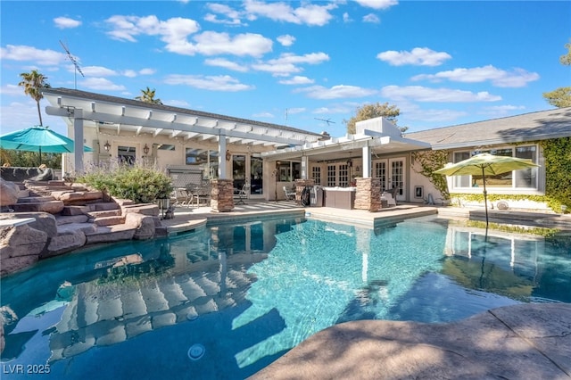 view of pool with french doors, a patio area, and exterior bar