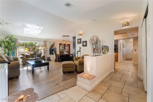 living room with lofted ceiling and light wood-type flooring