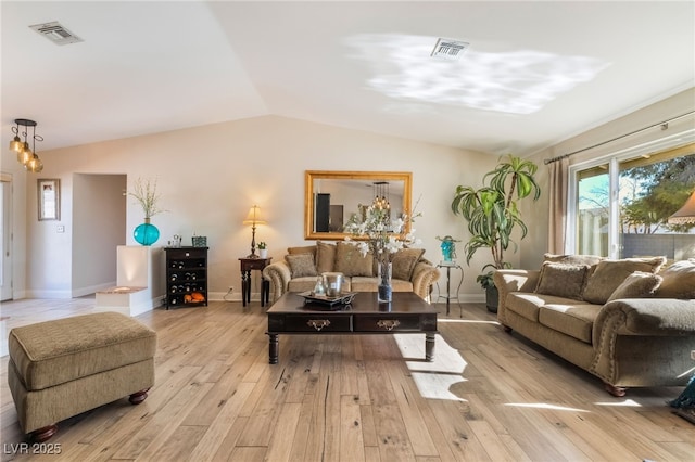 living room featuring light hardwood / wood-style floors and lofted ceiling