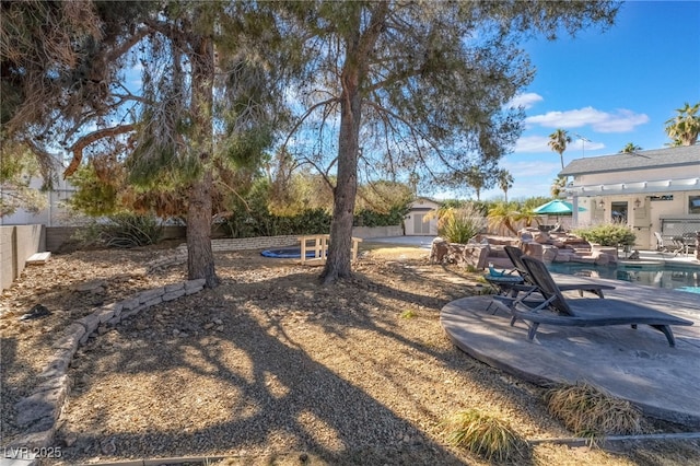 view of yard featuring a fenced in pool and a patio area