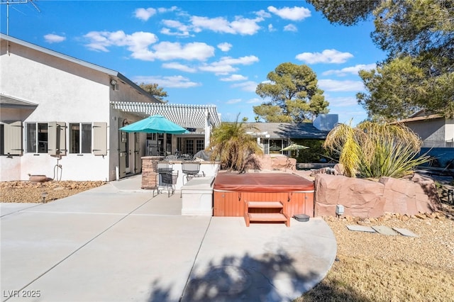 view of patio / terrace featuring a pergola and a hot tub