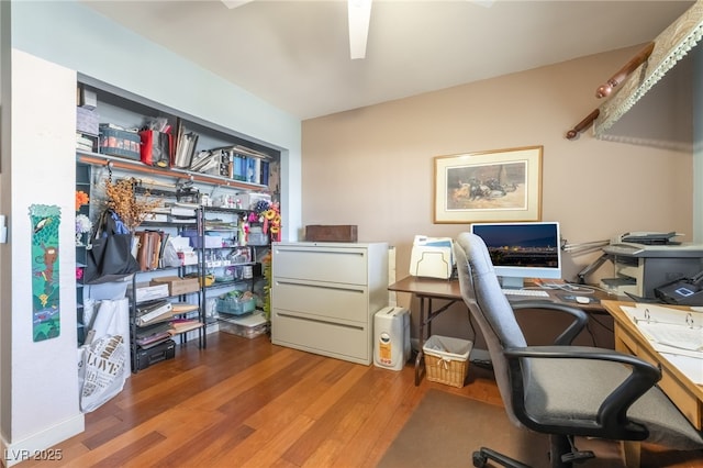 home office with hardwood / wood-style flooring