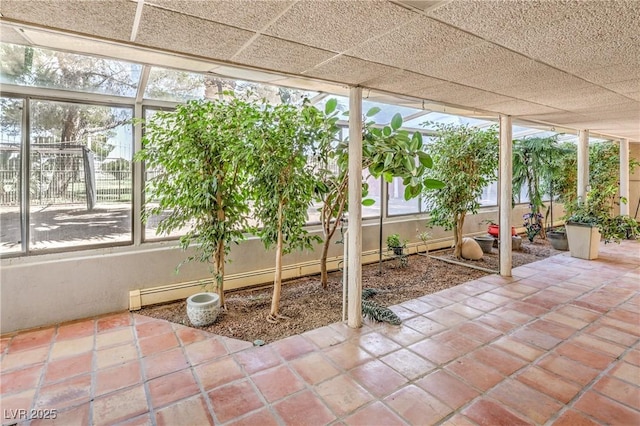 unfurnished sunroom with baseboard heating and plenty of natural light